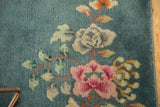 Art Deco rug's rose, ivory, and tangerine floral bouquet, featuring secured side selvage.