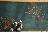 Art Deco runner's time-softened dusty blue field, showing diagonal rose and green floral patterns.