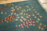 Close-up of variegated floral and leaf motifs on the dusty blue Art Deco runner.