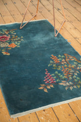 Corner of Chinese Art Deco rug, delicate rose and orange floral ornament, intact woven end.