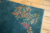 Nichols Art Deco rug, denim blue field with delicate floral ornamentation and secured selvage.
