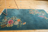Vintage Nichols Art Deco rug with sprawling asymmetric floral bouquets on a deep blue field.
