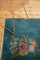 Asymmetric floral bouquet in rose, tangerine, ivory on a vintage Nichols Art Deco rug.