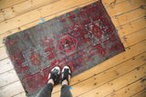 Vintage Karaja rug showing its central geometric medallion and patterned field in muted red and blue.