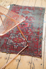 Geometric medallion and blossom motifs on vintage Karaja rug in brick red, sky blue.