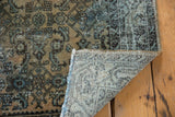 Distressed Hamadan runner showing worn herati motif pile and hand-knotted foundation.