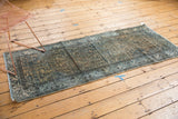 Faded camel and blue Herati motif on distressed vintage Hamadan runner, pile wear visible.