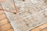 Distressed Karaja style Hamadan rug with faded geometric patterns, visible knot heads, and pale blue tones.