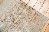 Distressed vintage Hamadan rug showing worn pile, knot heads, faded geometric design in ivory and brown.