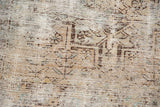 Distressed texture of vintage Hamadan rug, showing foundation with faded geometric patterns.