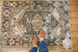 Distressed Hamadan rug, geometric medallion, floral buds, visible foundation, ivory, teal, brown.