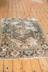 Distressed Hamadan rug detail with faded geometric patterns and exposed foundation.
