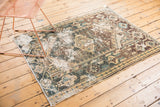 Worn texture and geometric pearl border detail of a vintage distressed Hamadan rug.