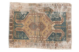 Distressed vintage Hamadan rug, worn geometric medallion, faded teal and gold tones.