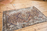 Distressed vintage Hamadan rug, revealing cobalt blue medallion, herati motifs, and foundation.