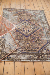 Distressed Hamadan rug close-up, revealing sharply serrated medallion, herati motif, and worn foundation.