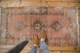 Distressed Hamadan rug runner, close-up of central medallion with exposed foundation.