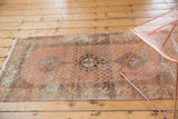 Distressed vintage Hamadan runner, highlighting faded rose, blush, mint green, and exposed foundation.