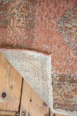 Distressed Hamadan runner showing hand-knotted back, worn pile, and secured fringe.