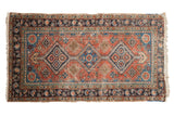 Antique Heriz runner, terra cotta field, triple blue diamond medallions, and running water channels.