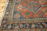 Intricate polychrome borders with geometric and floral motifs on an antique Heriz rug, with even wear.