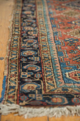 Polychrome side cord selvages and intricate navy border of antique Heriz runner.
