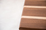 Thick mahogany and maple serving board with contrasting light and dark wood strips.