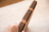 Thick, faceted mahogany and maple wood edge of the serving board.