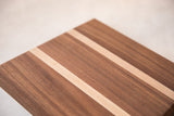 Mahogany and maple wood serving board, showing striped pattern and rich grain.