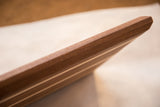 Thick mahogany and maple serving board, displaying contrasting wood stripes and chamfered end.