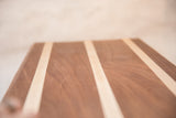 Mahogany and maple serving board showing natural wood grain and contrasting strips.