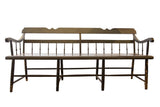 Antique Deacon's Bench with distressed dark green paint, spindle back, and worn patina.