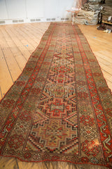 Antique Kurdish runner end, geometric red-orange and camel pattern, with worn fringe.
