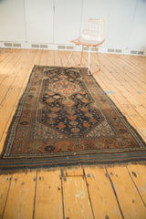 Frayed, hand-knotted fringe and geometric border of the Antique Kamseh runner in deep blue and copper.