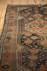 Antique Kamseh runner's geometric border in copper, ivory, and dark blue, with even pile wear.