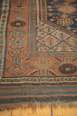 Secure fringe and geometric border in copper, dark blue on this antique Kamseh rug.