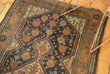Geometric scale motif in rich copper, dark blue, and ivory on this antique Kamseh rug.