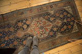 Hand-knotted antique Kamseh runner's secure fringe and geometric border, showcasing wooded shades.