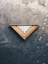 Triangular 1767 Designs Art Trinity wood art, natural grain, white stepped pattern.