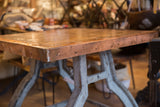 Copper top table corner with riveted edging and industrial bronze base.
