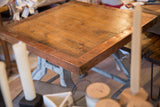 Close-up of reclaimed wood table top with copper edging and rivets.