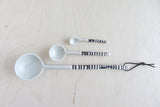Large grey ceramic spoon, handmade with black striped handle, 11 inches long.