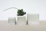 Small storm grey ceramic planter with herringbone pattern, part of a set.