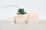 Small peach ceramic planter featuring a black herringbone pattern, 2x2x2.