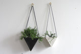 Handmade white porcelain triangle hanging planter, shown with a black one.
