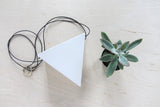 7-inch white porcelain triangle planter with black waxed cotton cord and brass ring.