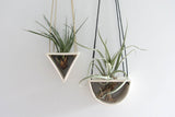 Open triangle porcelain air plant hanger, handmade, with visible light hanging cord.