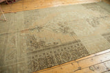 Vintage Oushak rug showing abrash, stepped border, and scrolling floral motifs.