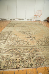 Vintage Oushak carpet corner with fringe, abrash, and ornate floral border.