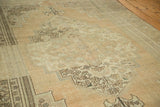 Vintage Oushak carpet detail: beige medallion with stepped borders, scrolling leaves, and abrash.